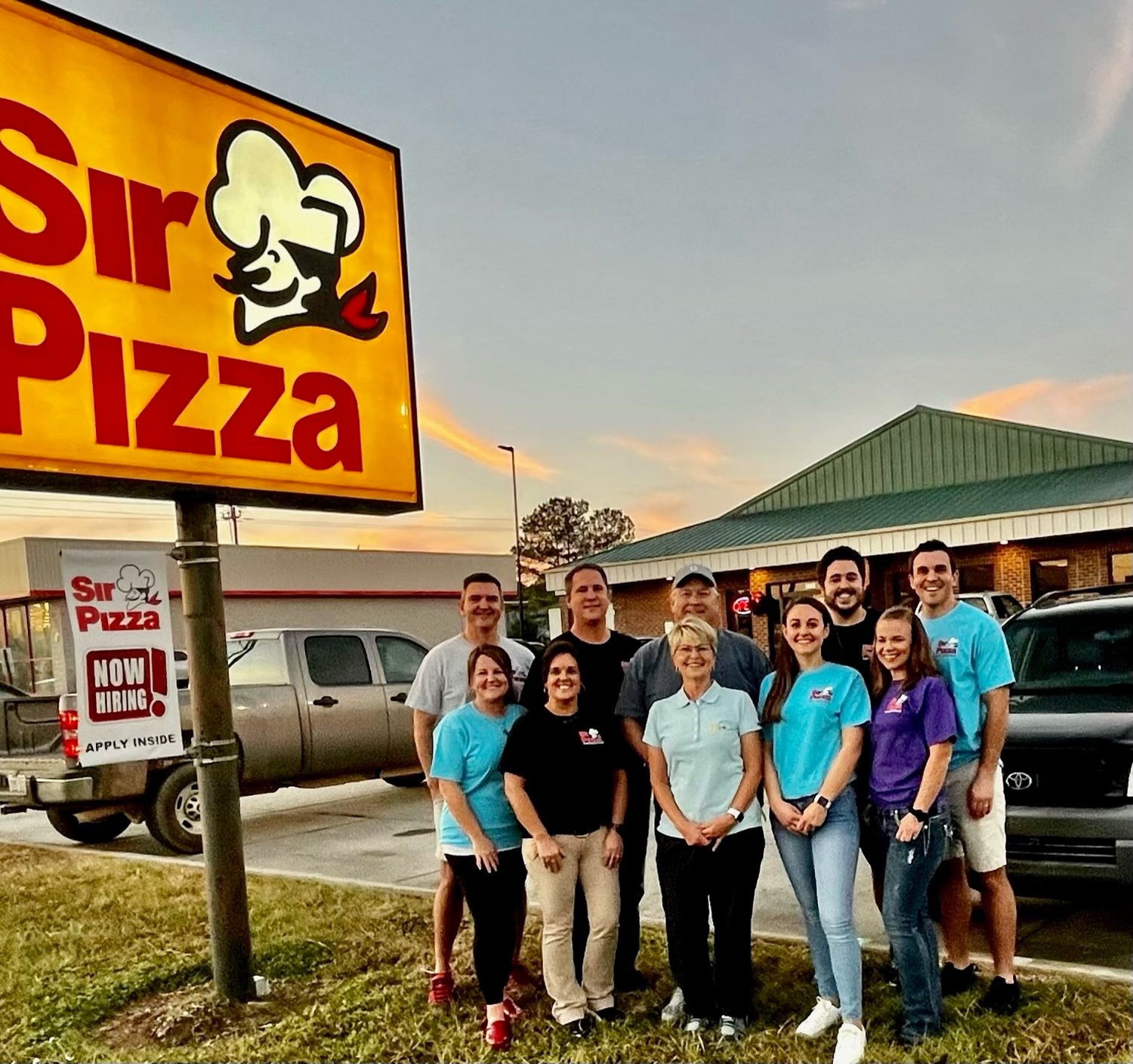 Former Sir Pizza owners Jeff and Ann Shaw (back and front center) standing with members of the Edminsten and Cox families, the restaurant's new owners.